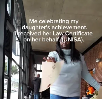 Khethiwe holding her daughter's UNISA Law Certificate